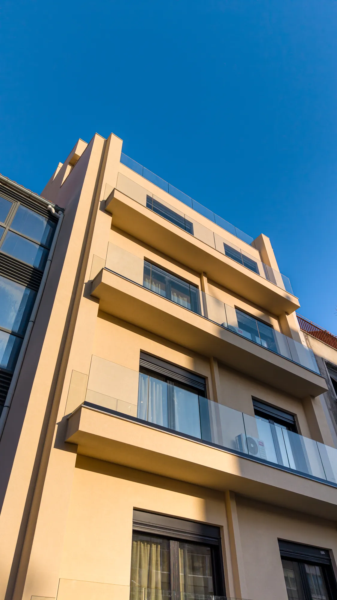 ORMOS Piraeus, the facade from below, balconies against a blue sky