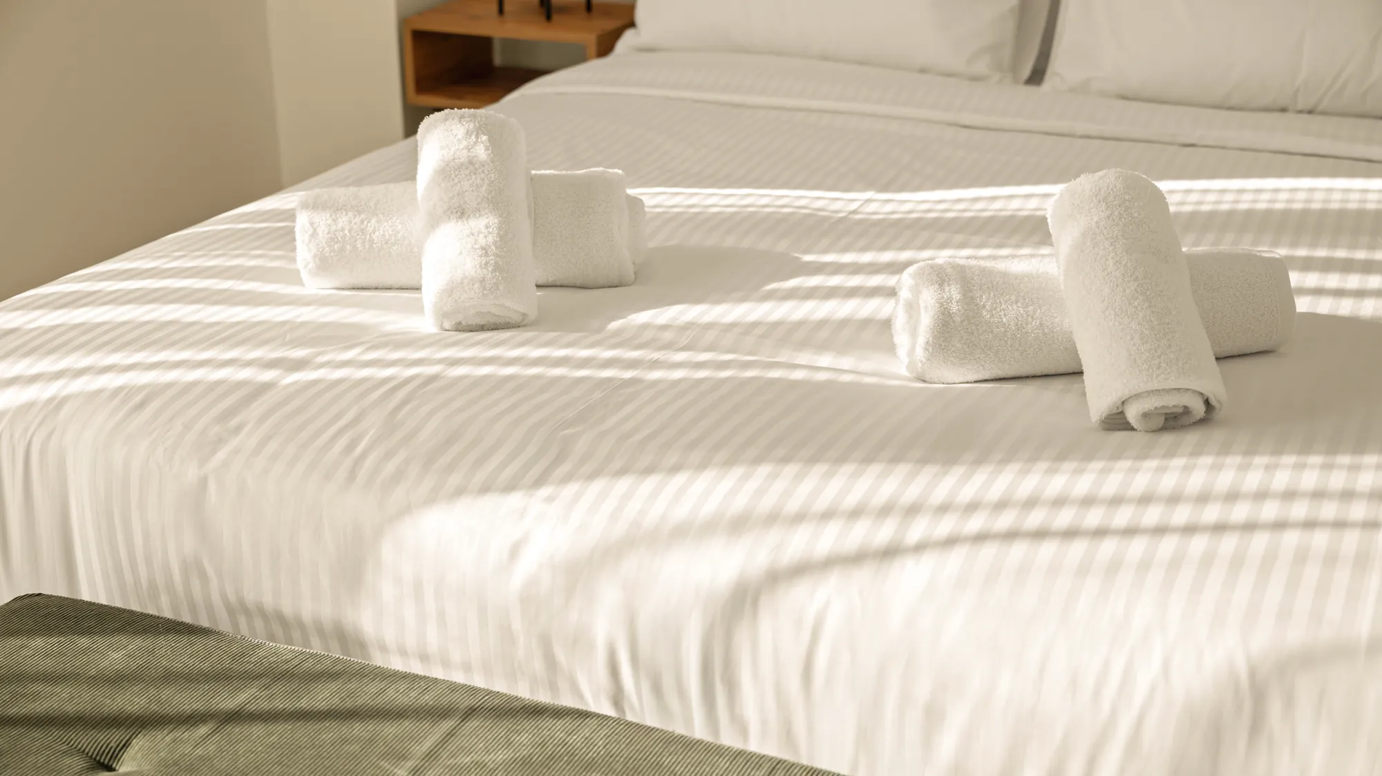 ORMOS Piraeus, towels on the bed in afternoon light