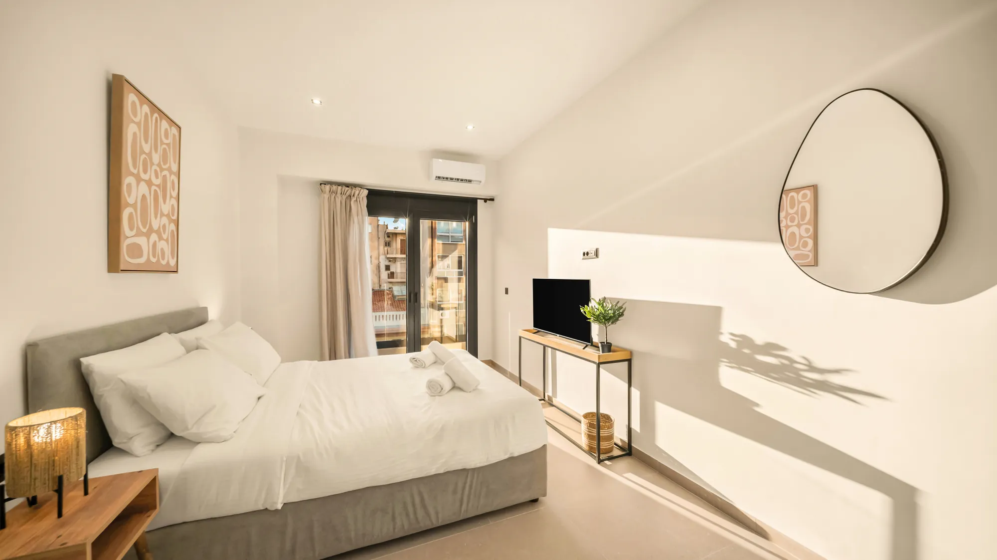 ORMOS Piraeus, the bed and the round mirror in afternoon light