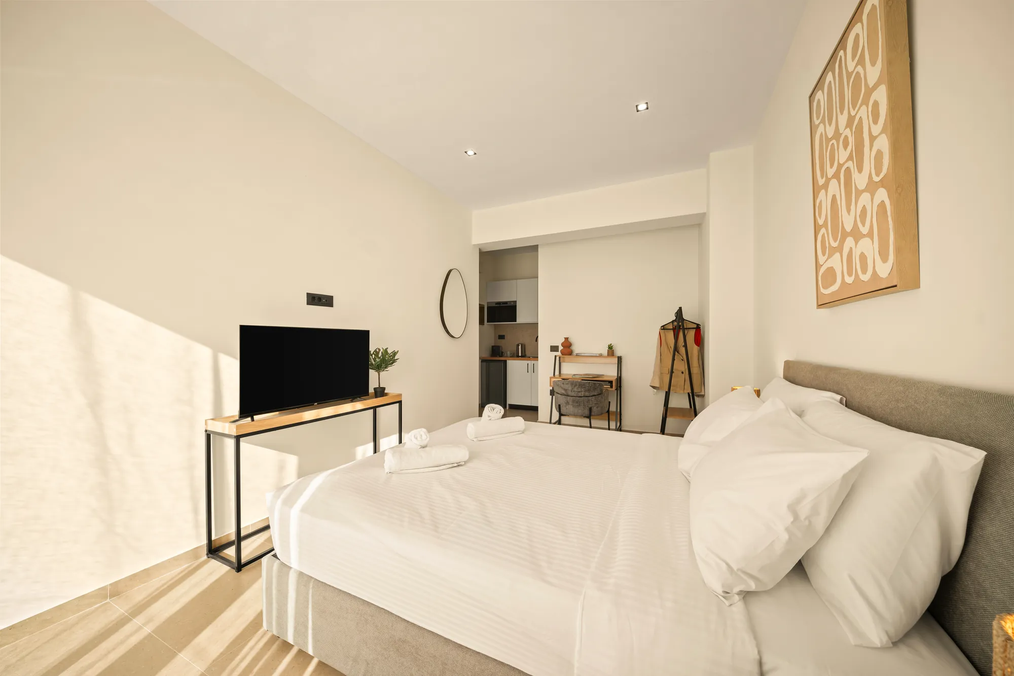 ORMOS Piraeus, the bed, the television and the kitchenette at the far end