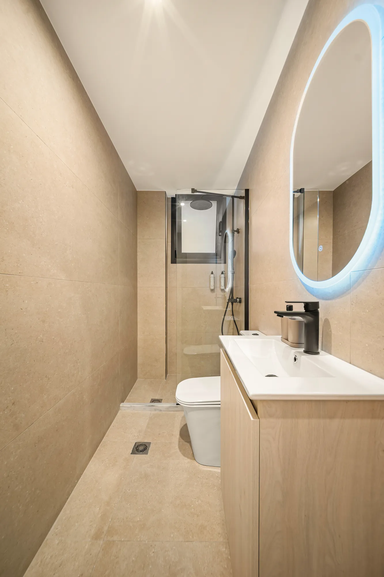 ORMOS Piraeus, the bathroom with the lit oval mirror