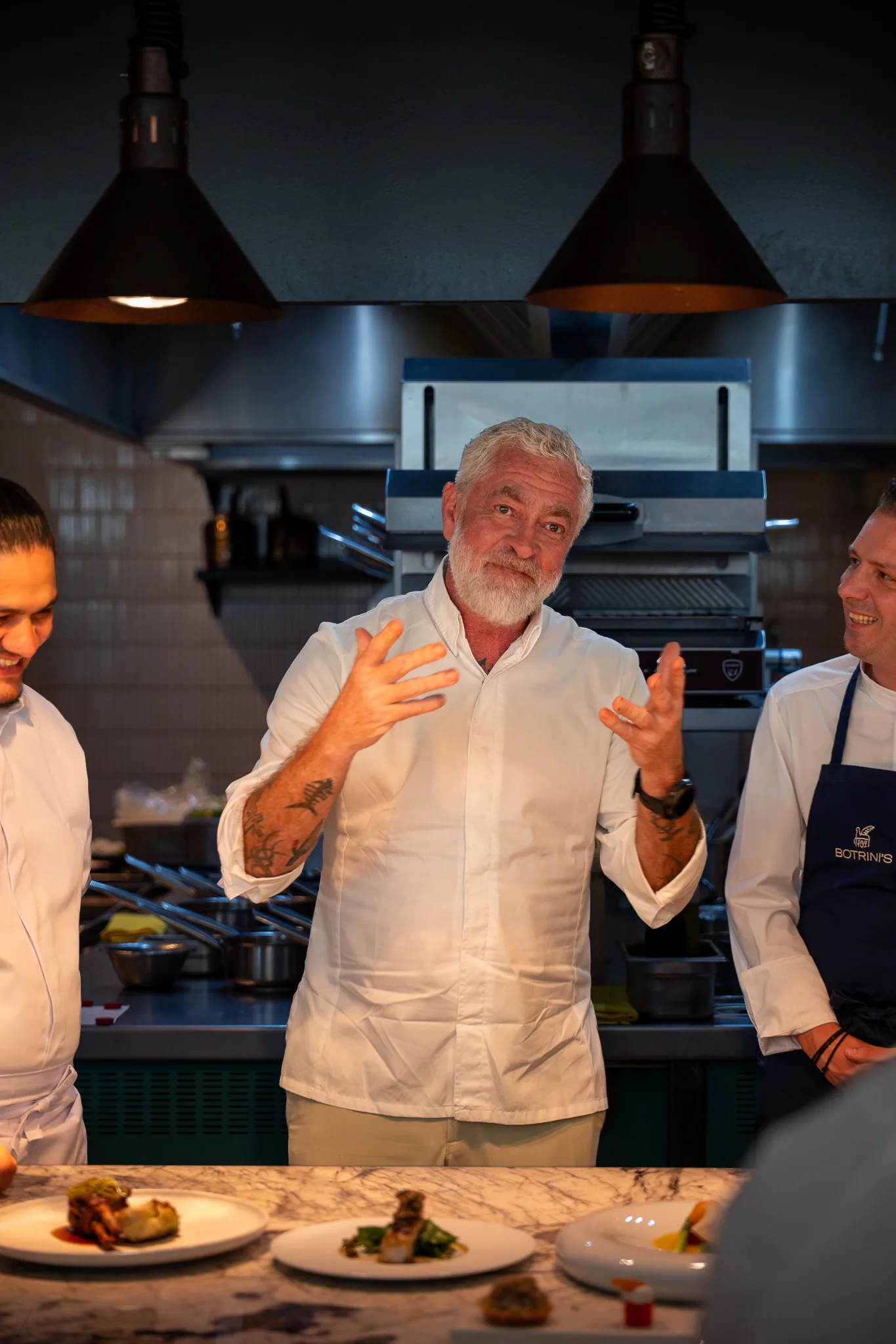 The chef with the kitchen team behind the line